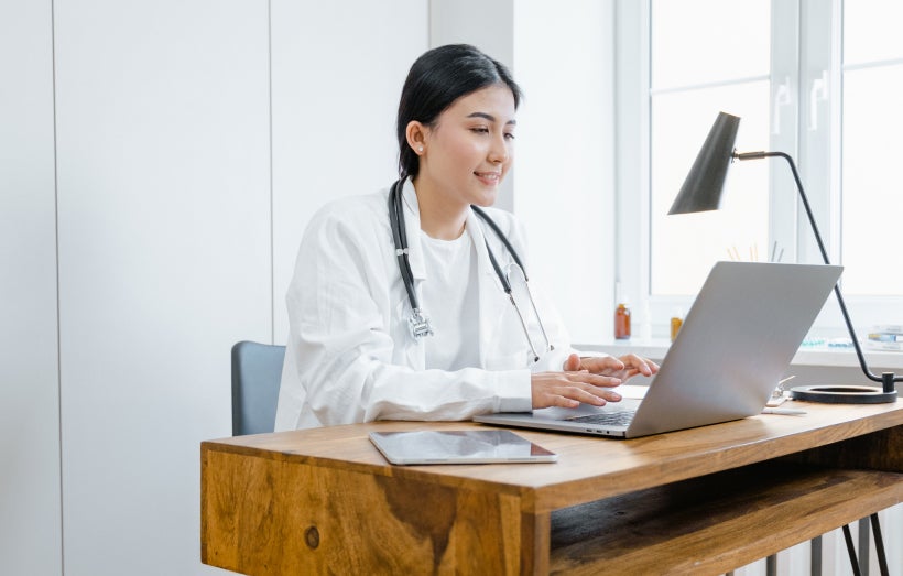 Healthcare worker on laptop